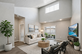 Living room with vaulted ceilings and patio access